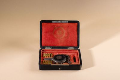 a black case with a pair of scissors inside of it