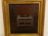 painting of a gold frame with a picture of a box in it
