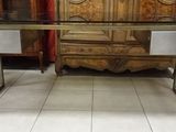 a glass table with a metal base in a room