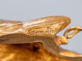 a close up of a gold statue of a bird