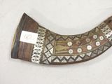 a horn shaped object on a table with a tag on it