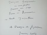 an open book with a handwritten poem on it sitting on a table
