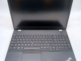 the laptop is open on a white surface with a black keyboard