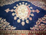a large blue rug with a medallion design on it