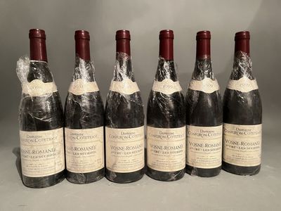 six bottles of red wine are lined up in a row