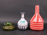 three vases sitting next to each other on a table