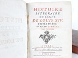 an old book that is open on a table
