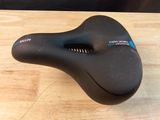 a close up of a bicycle seat on a wooden table