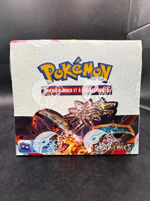 a box of pokemon trading cards sitting on top of a table