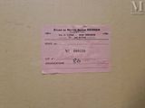 a picture of a pink ticket on a brown box