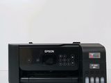a black printer sitting on top of a white table