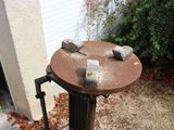 a fire hydrant that has two rocks on top of it