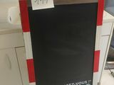 a black and red sign on the floor in the kitchen