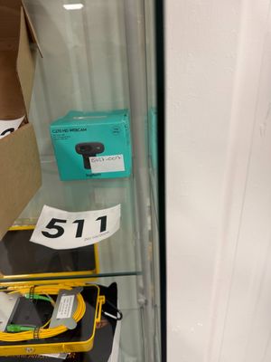 a display case with a phone and other items in it