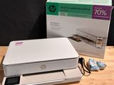a white printer sitting on top of a table next to a box