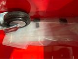 a close up of a wheel on a red surface