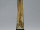a large horn shaped object on a stand on a white surface