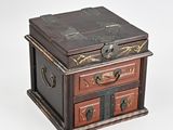 a small wooden box with three drawers on top of it