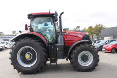a picture of a red tractor parked in a parking lot