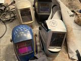 several welding helmets are sitting on a table in a workshop