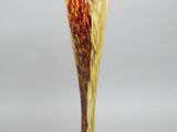 a glass vase with a brown and yellow design on it