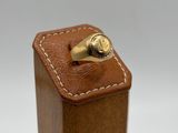 a close up of a wooden box with a ring on top of it