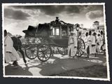 a black and white photo of a horse drawn carriage