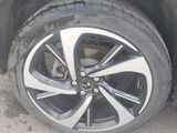 a close up of a tire on a car in a parking lot