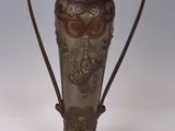 a metal vase with a handle on a white background