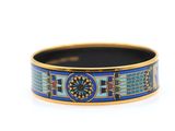 a close up of a blue and gold bracelet on a white background