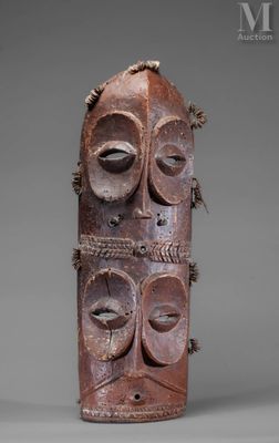 an old wooden mask with two faces and a rope around it