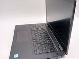 a laptop computer sitting on a table with a keyboard