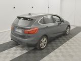 the back end of a grey car parked in a garage