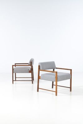 two chairs in a room with a white floor and a white wall