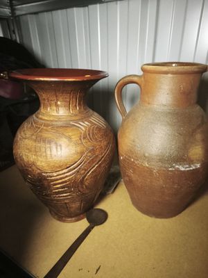 two vases that are sitting on a table