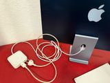 a red table with a computer and a charger on it