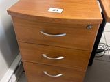 a wooden desk with a computer on top of it