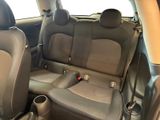 the back seats of a car with a cup holder in the center