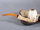 a picture of a pipe and a skull in a bowl