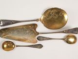 three spoons and a spoon rest on a white surface