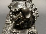 a statue of a man riding a horse on top of a lion