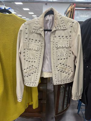 two jackets hanging on a rack in a clothing store