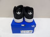 men ' s adidas sneakers in black and white on a blue box