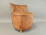 a chair that is made out of wood and has a seat made out of leather
