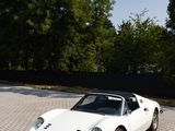 an image of a white sports car parked in a parking lot