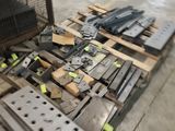 many pieces of metal on a pallet in a warehouse