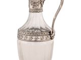 an antique silver plated glass pitcher with a handle