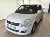 a small white car parked in a garage