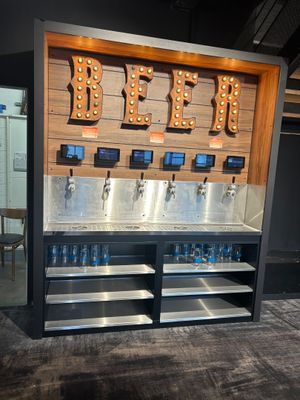 a beer dispenser with a lot of bottles on it