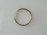 a close up of a gold ring on a white surface